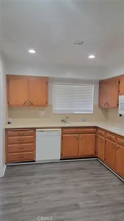 a view of a kitchen counter space and wooden floor