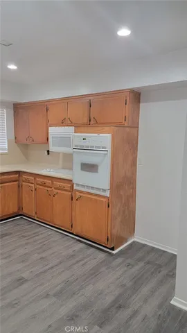 a kitchen with a cabinets and wooden floor