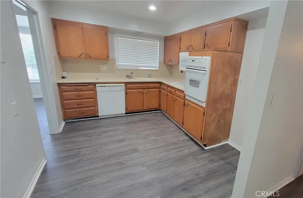 a kitchen with white cabinets and white appliances