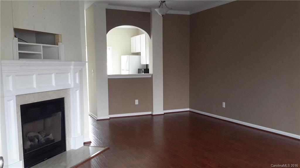311 Sugar Ridge Court, Unit 109 Fort Mill, SC 29708 - Photo 3 of 23 an empty room with wooden floor fireplace and windows
