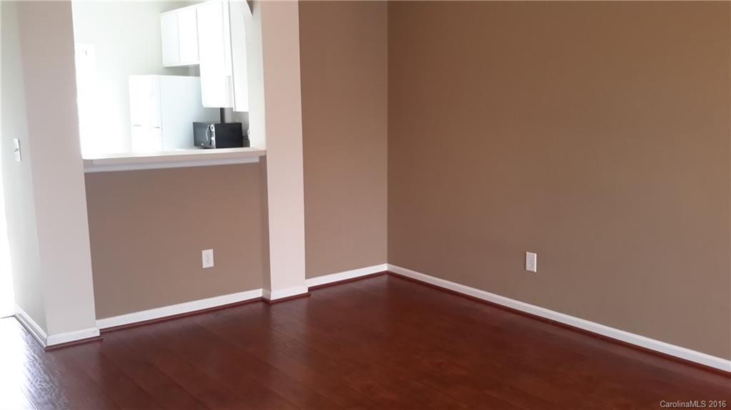 311 Sugar Ridge Court, Unit 109 Fort Mill, SC 29708 - Photo 4 of 23 an empty room with wooden floor and windows