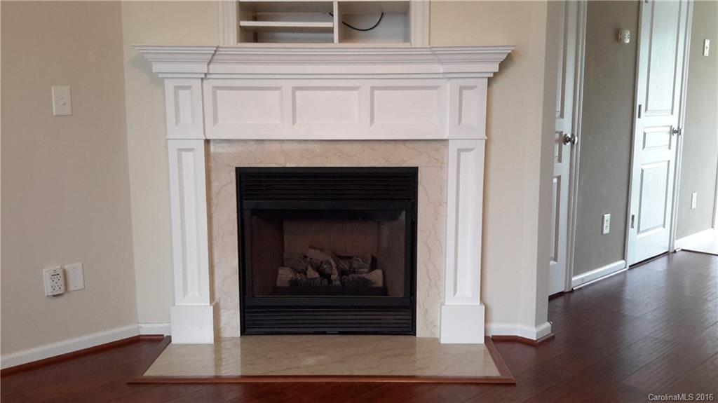 311 Sugar Ridge Court, Unit 109 Fort Mill, SC 29708 - Photo 5 of 23 a living room with a fireplace and wooden floor