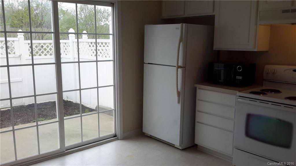 311 Sugar Ridge Court, Unit 109 Fort Mill, SC 29708 - Photo 7 of 23 a kitchen with a refrigerator and a stove