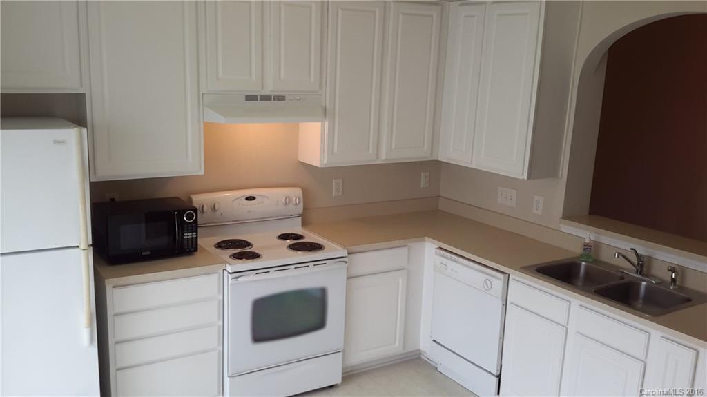 311 Sugar Ridge Court, Unit 109 Fort Mill, SC 29708 - Photo 8 of 23 a kitchen with white cabinets and white appliances