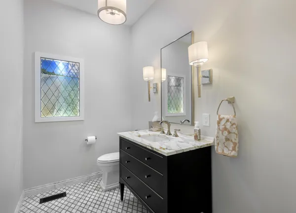 a bathroom with a sink a toilet and a mirror
