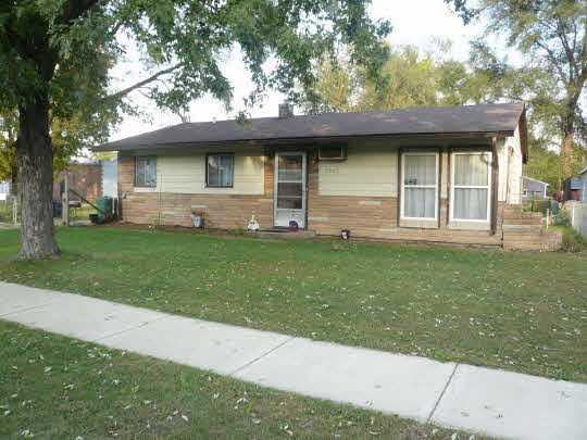 7907 Randy Road Machesney Park, IL 61115 - Photo 1 of 1 a front view of a house with a yard and garage