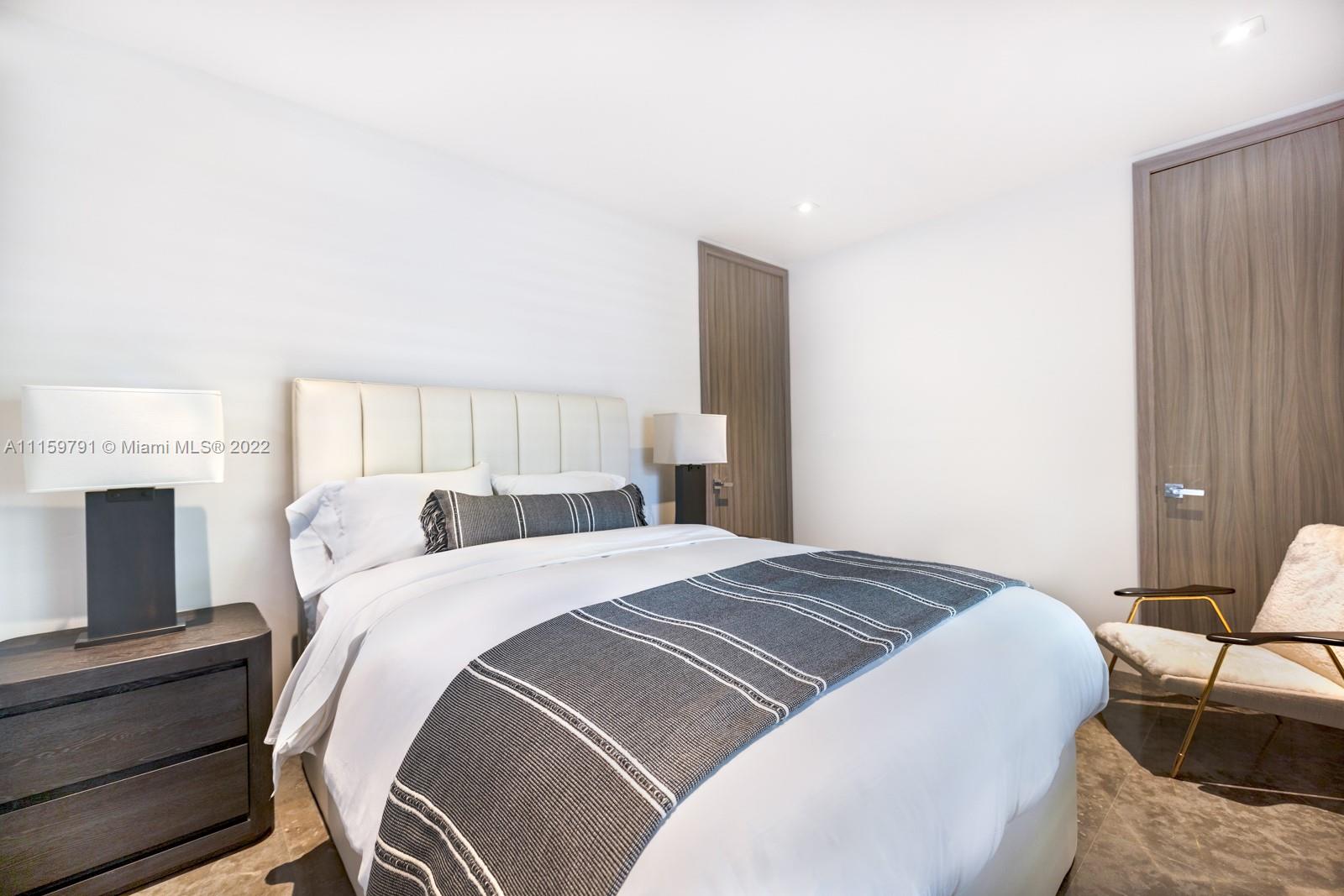 1540 Cleveland Road Miami Beach, FL 33141 - Photo 16 of 28 a bedroom with a bed and a fireplace