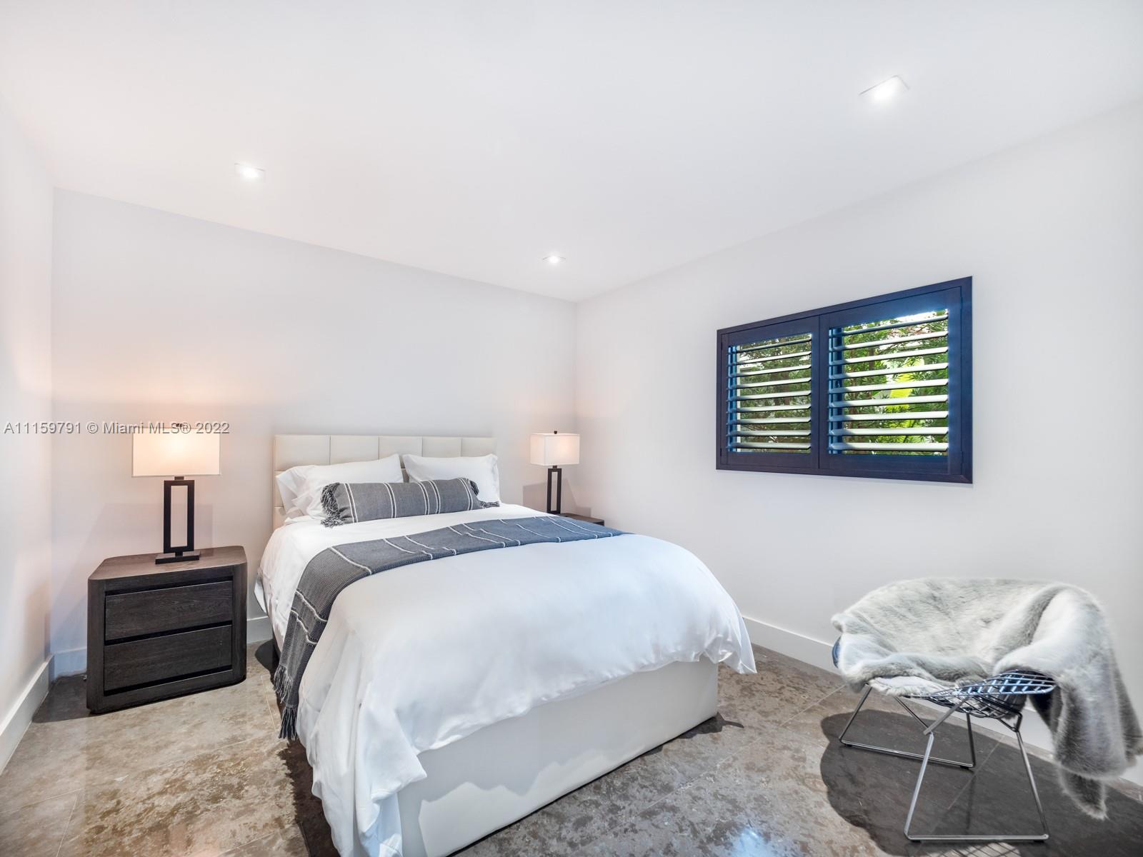 1540 Cleveland Road Miami Beach, FL 33141 - Photo 18 of 28 a bedroom with a bed and a window