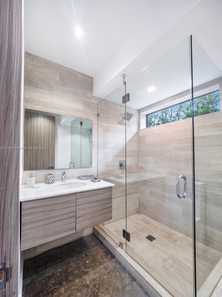 1540 Cleveland Road Miami Beach, FL 33141 - Photo 20 of 28 a bathroom with a shower sink and mirror