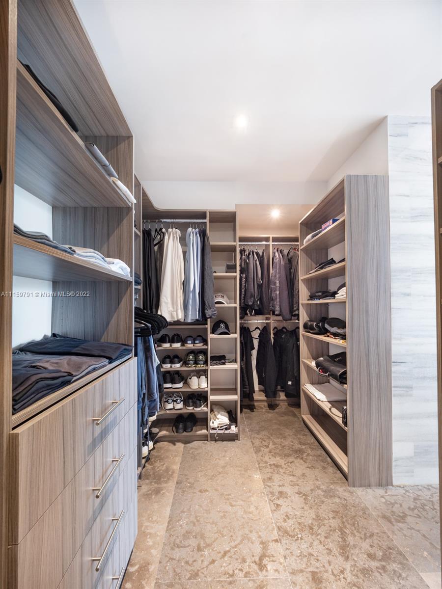 1540 Cleveland Road Miami Beach, FL 33141 - Photo 7 of 28 a view of walk in closet with clothes and shoes