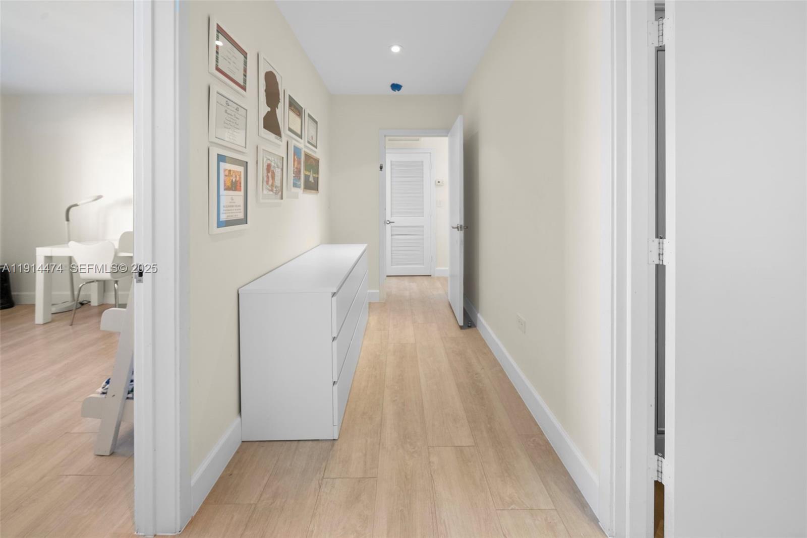 200 Ocean Ln Drive, Unit 501 Key Biscayne, FL 33149 - Photo 52 of 71 a view of a hallway with wooden floor and a bathroom