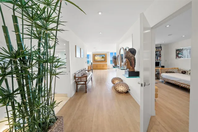 a living room with furniture large window and a table