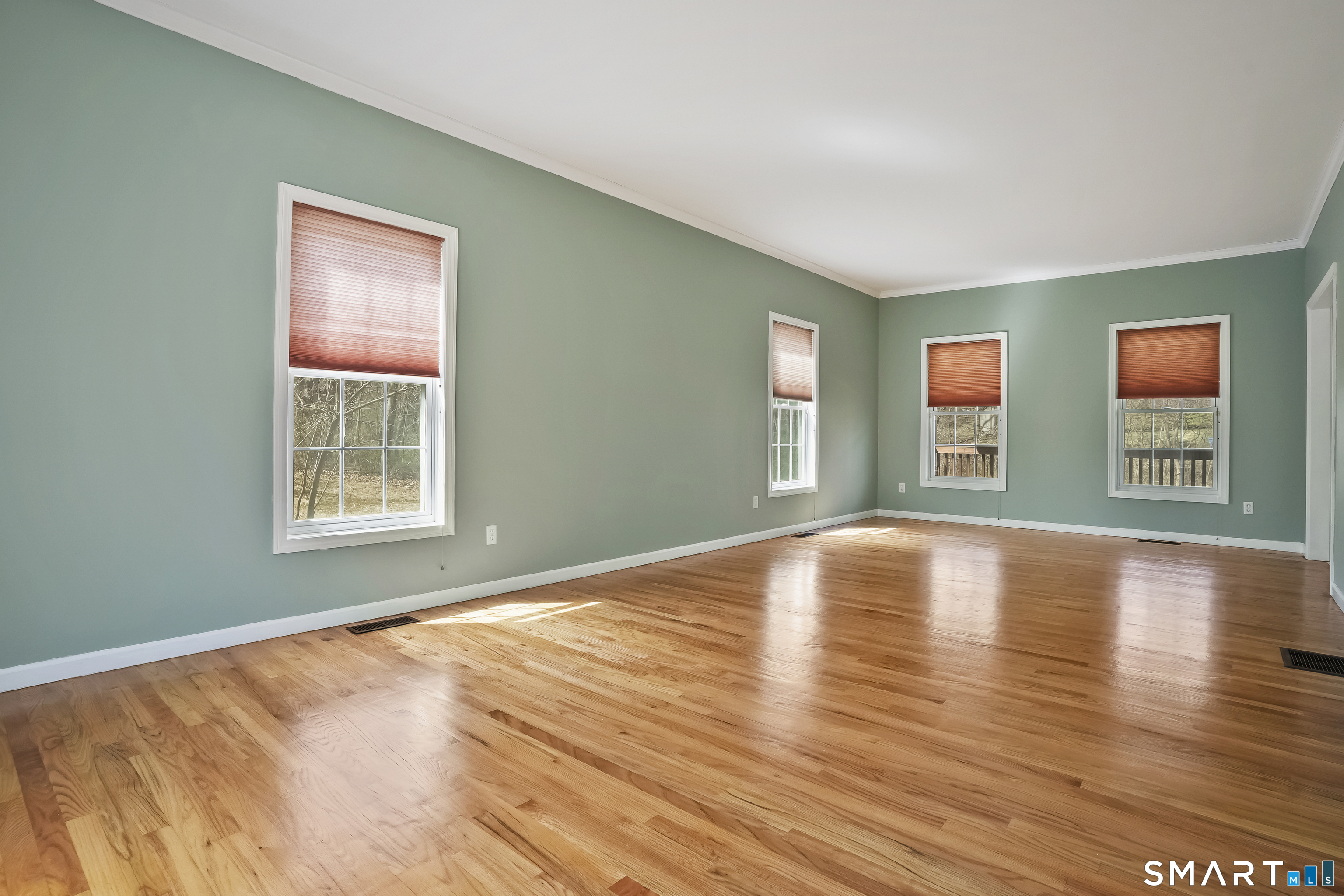 72 Perry Hill Road Shelton, CT 06484 - Photo 15 of 36 a view of an empty room with window and wooden floor