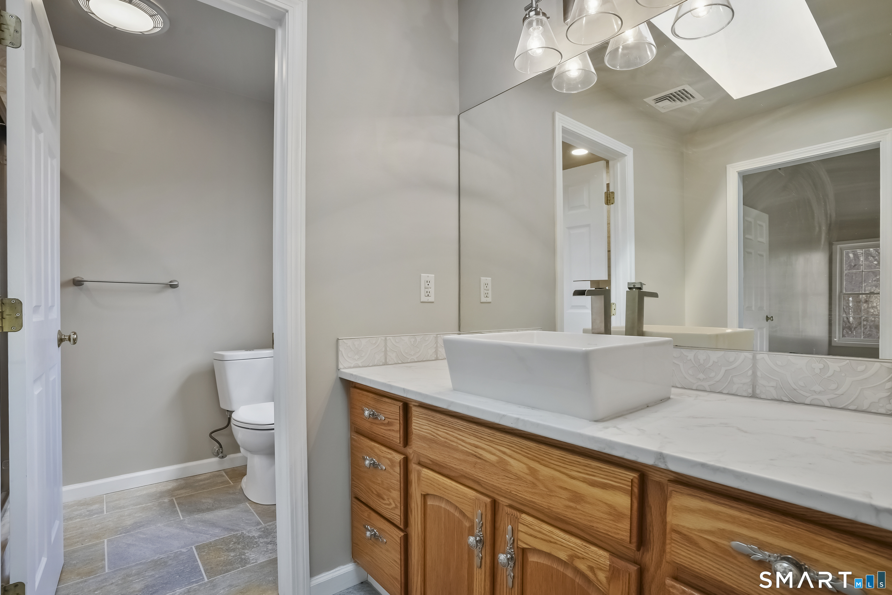 72 Perry Hill Road Shelton, CT 06484 - Photo 25 of 36 a living room with a sink and a toilet