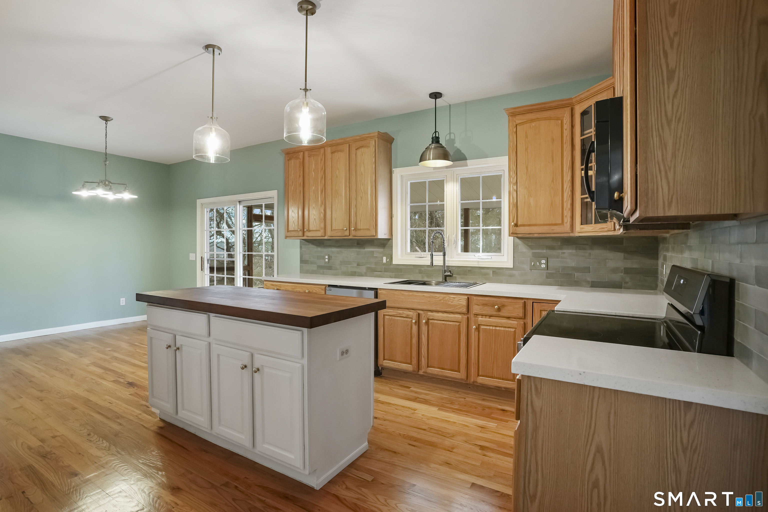72 Perry Hill Road Shelton, CT 06484 - Photo 6 of 36 a kitchen with stainless steel appliances granite countertop a sink a stove a refrigerator and island with wooden floor