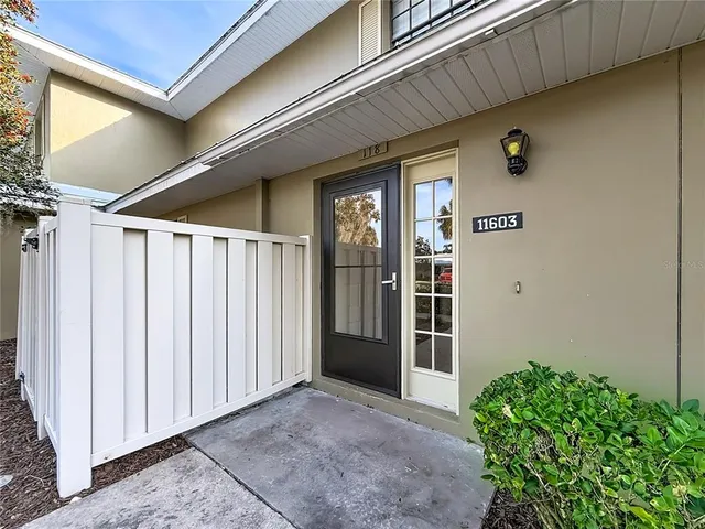 a view of a house with a yard and a garage