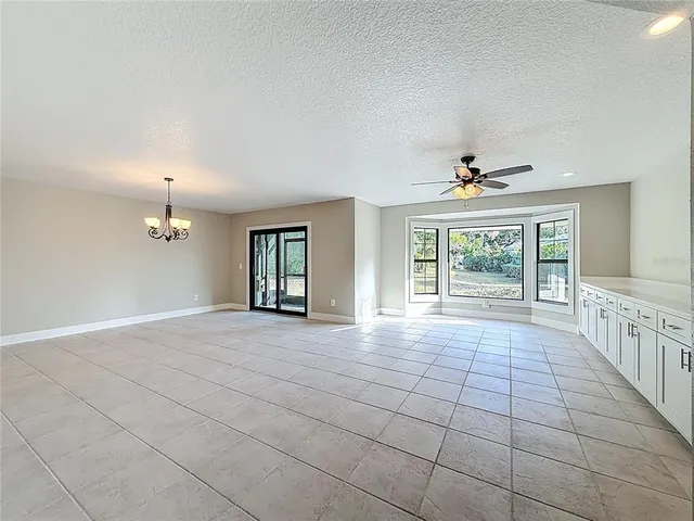 a dining room with furniture a chandelier and wooden floor