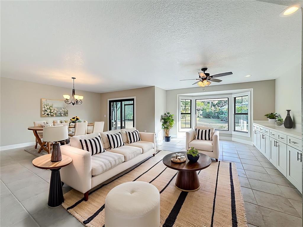 11603 West Bayshore Drive, Unit 118 Crystal River, FL 34429 - Photo 16 of 73 a living room with furniture and a chandelier