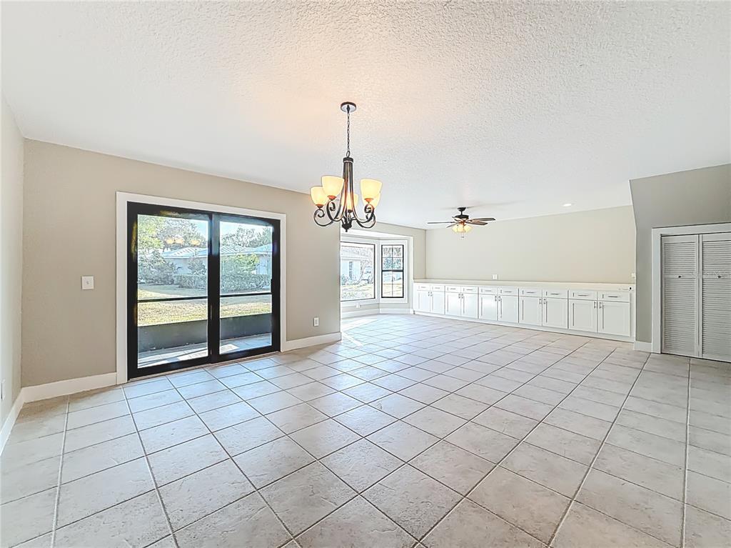 11603 West Bayshore Drive, Unit 118 Crystal River, FL 34429 - Photo 19 of 73 a view of a livingroom with a furniture chandelier and window