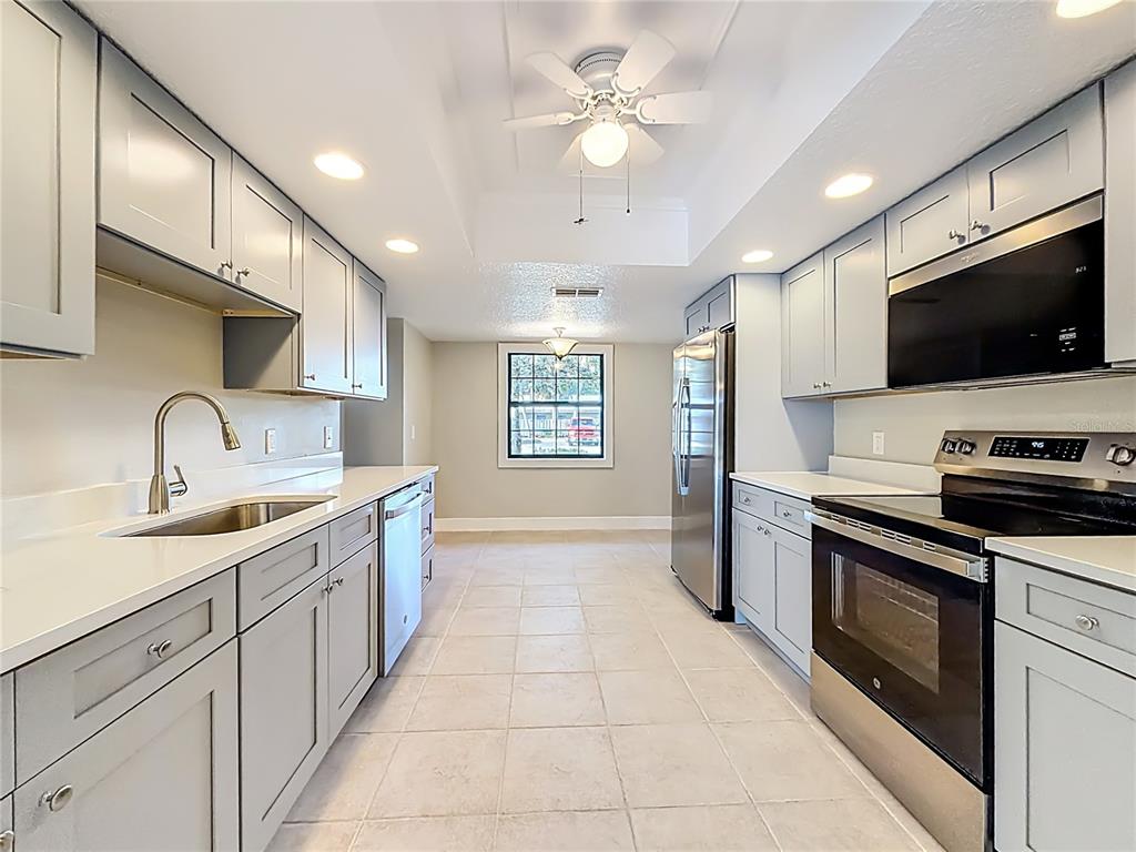 11603 West Bayshore Drive, Unit 118 Crystal River, FL 34429 - Photo 22 of 73 a kitchen with a sink stainless steel appliances and cabinets