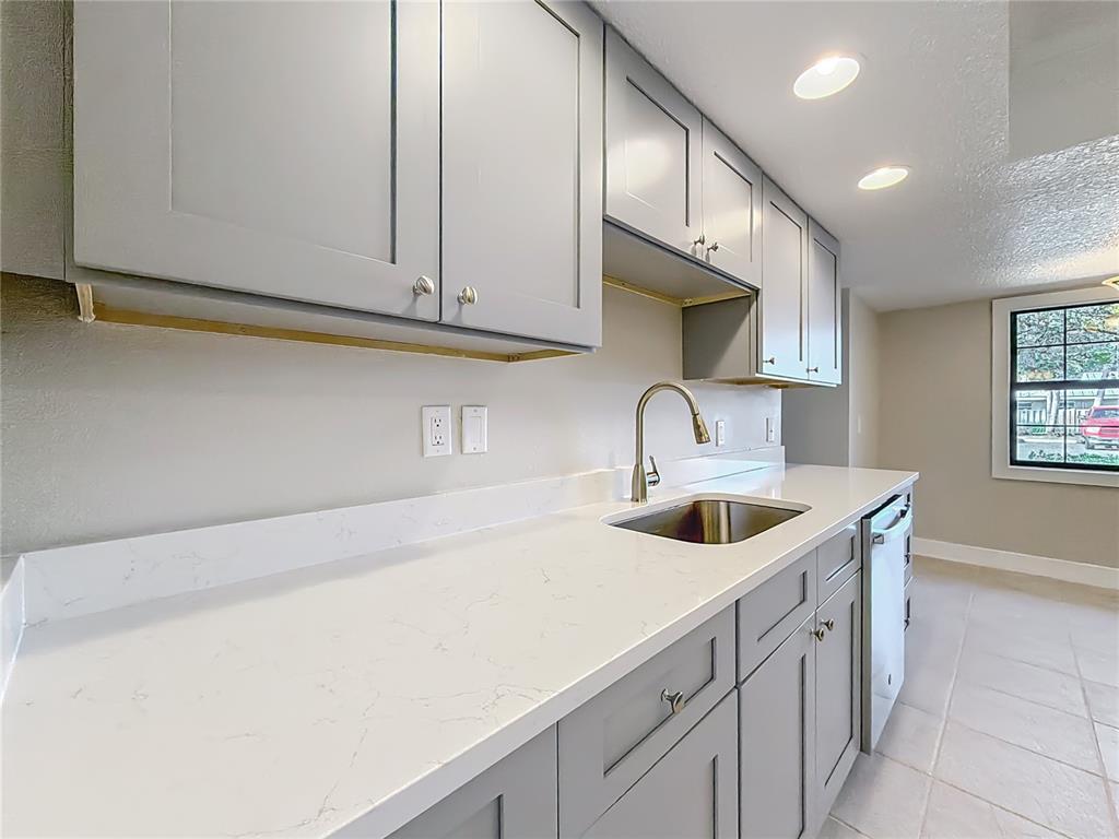 11603 West Bayshore Drive, Unit 118 Crystal River, FL 34429 - Photo 23 of 73 a kitchen with stainless steel appliances granite countertop a sink and cabinets