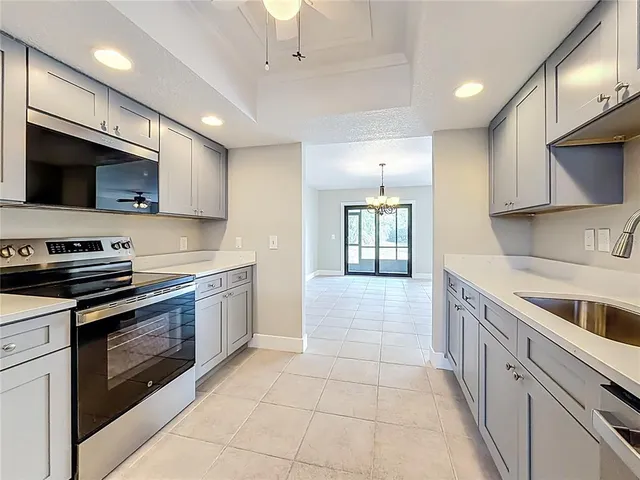 an empty room with closet and fan