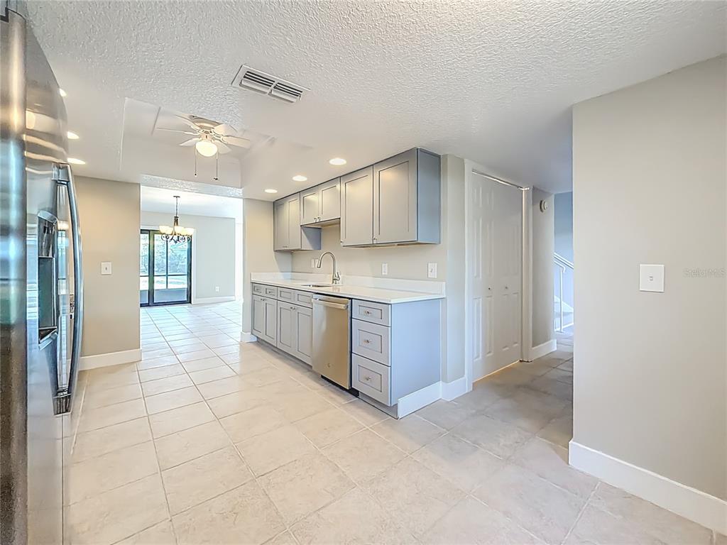 11603 West Bayshore Drive, Unit 118 Crystal River, FL 34429 - Photo 26 of 73 a large kitchen with stainless steel appliances a sink and cabinets