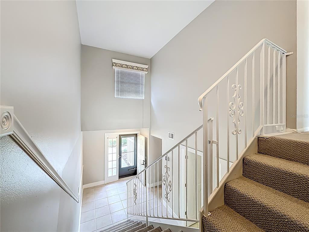 11603 West Bayshore Drive, Unit 118 Crystal River, FL 34429 - Photo 29 of 73 a view of staircase with wooden floor and a rug