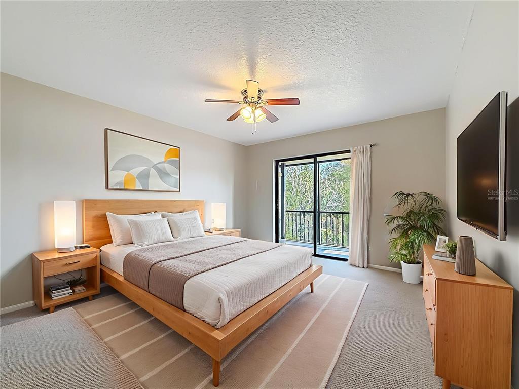 11603 West Bayshore Drive, Unit 118 Crystal River, FL 34429 - Photo 30 of 73 a bedroom with a bed and a flat screen tv