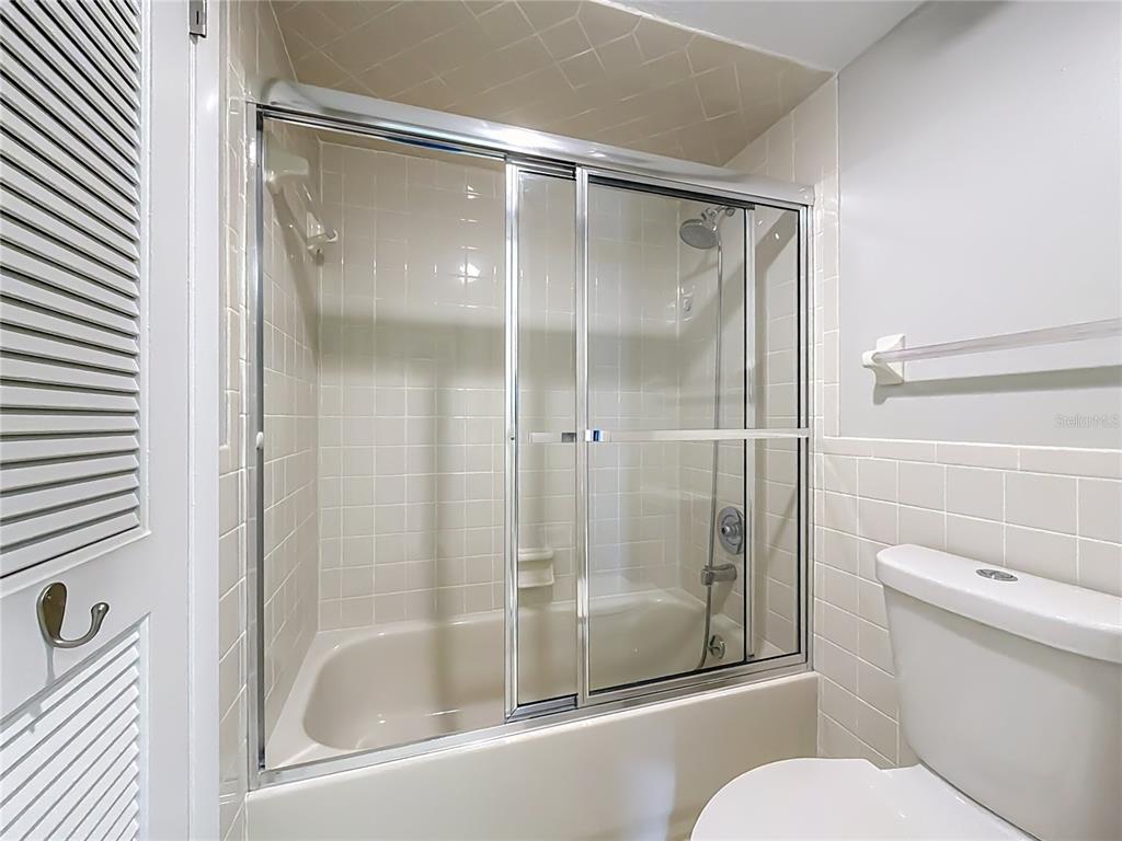 11603 West Bayshore Drive, Unit 118 Crystal River, FL 34429 - Photo 42 of 73 a bathroom with a glass shower door