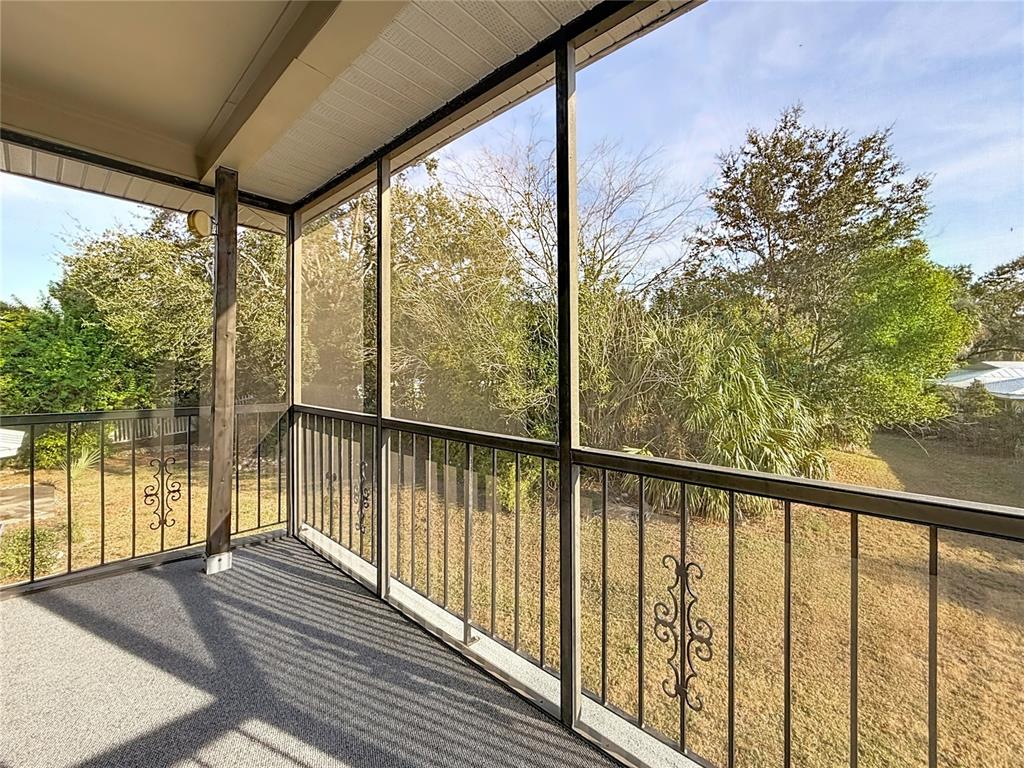 11603 West Bayshore Drive, Unit 118 Crystal River, FL 34429 - Photo 45 of 73 a view of balcony with floor to ceiling windows with wooden floor