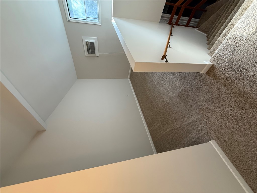 125 Maple Street, Unit 110 Pendleton, SC 29670 - Photo 13 of 18 A well-maintained staircase features carpet flooring leading to a sun-filled loft with a sloped ceiling.