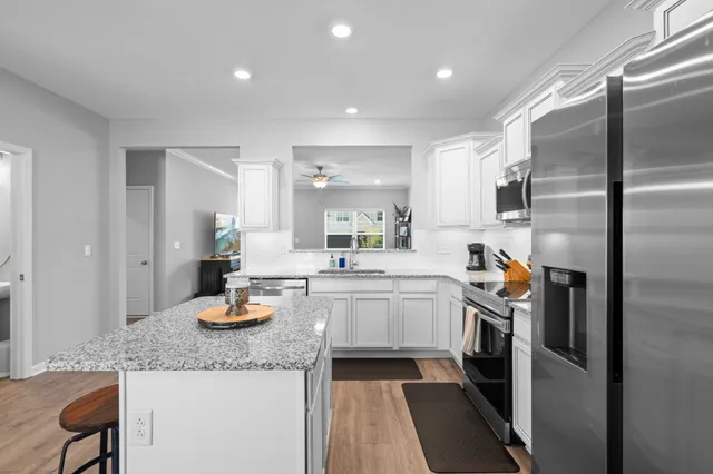 a kitchen with sink refrigerator and stove