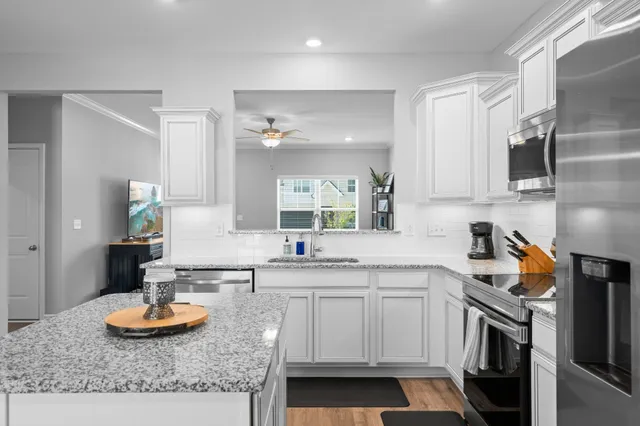 a kitchen with stainless steel appliances granite countertop a sink and a stove