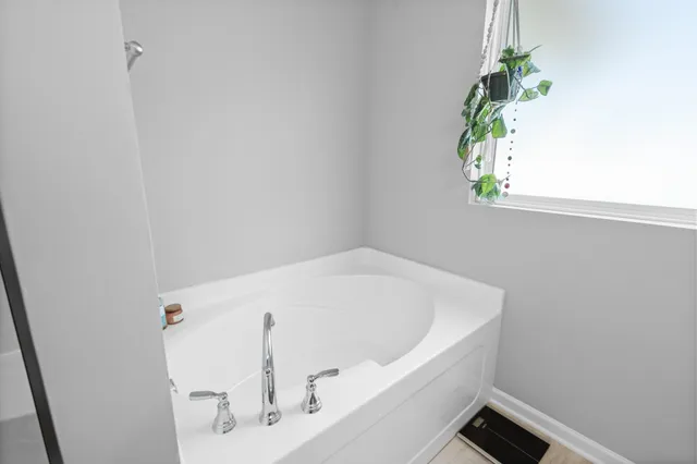 a white bath tub sitting in a bathroom