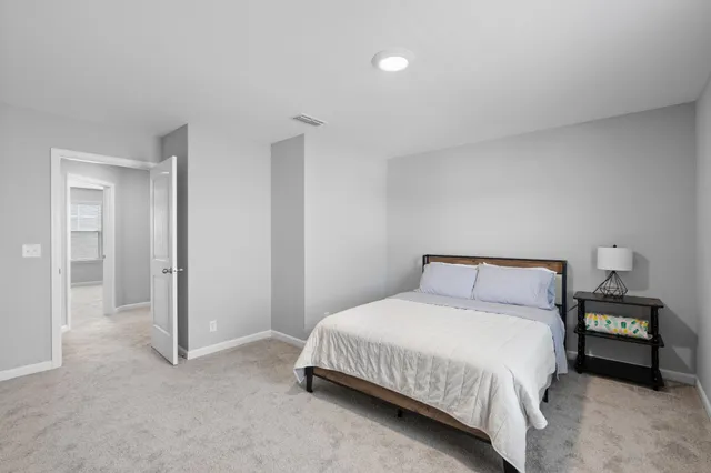 a bedroom with a bed and a night stand