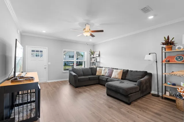 a living room with furniture and wooden floor