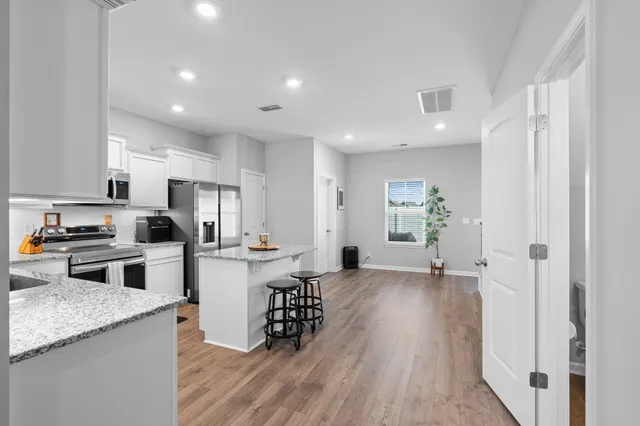 a kitchen with refrigerator and cabinets