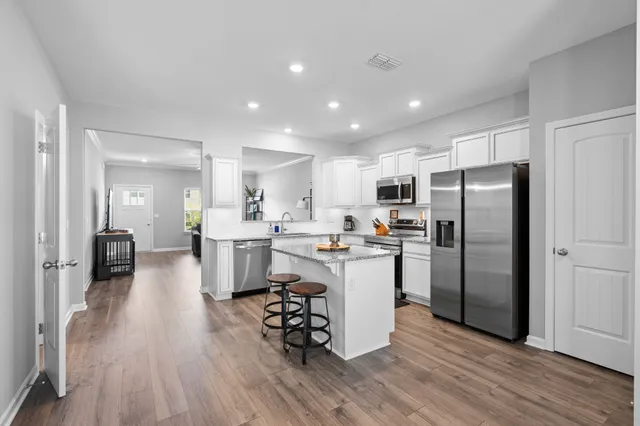a kitchen with a refrigerator a sink and a stove top oven
