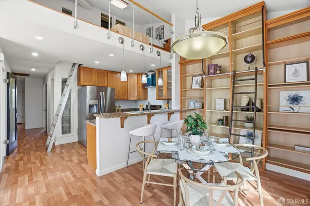 a view of a dining room with furniture and a chandelier