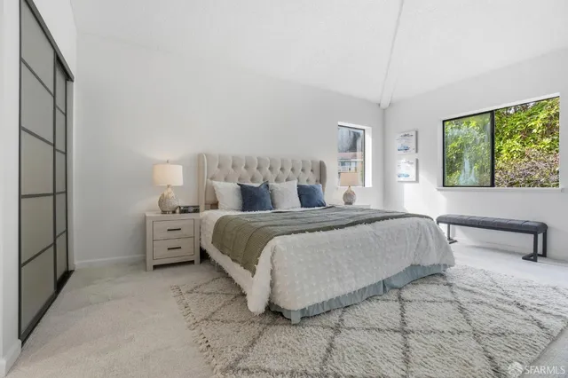 a bedroom with a bed and a large mirror