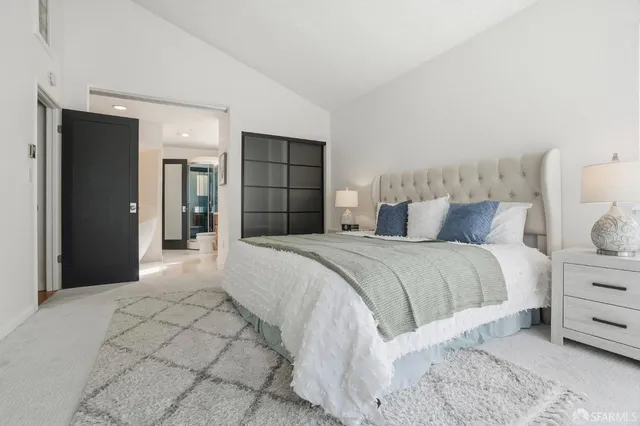 a bedroom with a large bed and a window