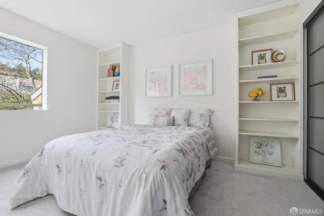 a bedroom with a bed and a walk in closet