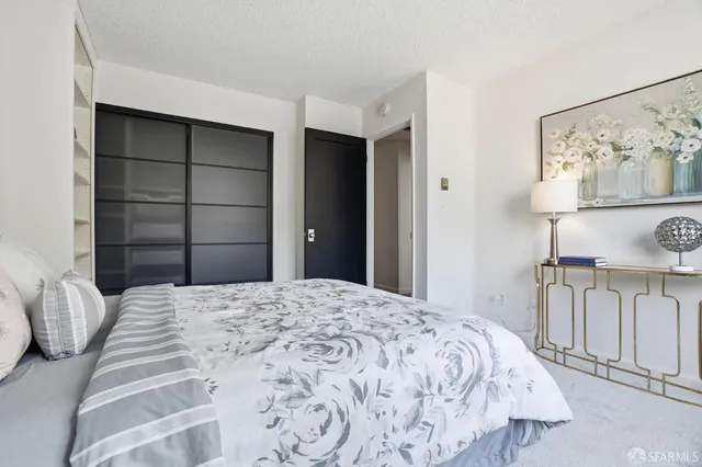 a bedroom with a large bed and a window