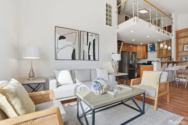 a living room with furniture and a dining table