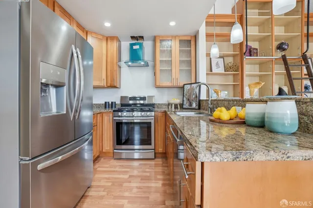a kitchen with a sink a counter top space and living room view
