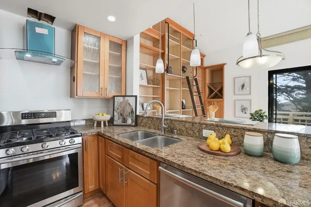 a view of a dining room and livingroom with furniture wooden floor a chandelier
