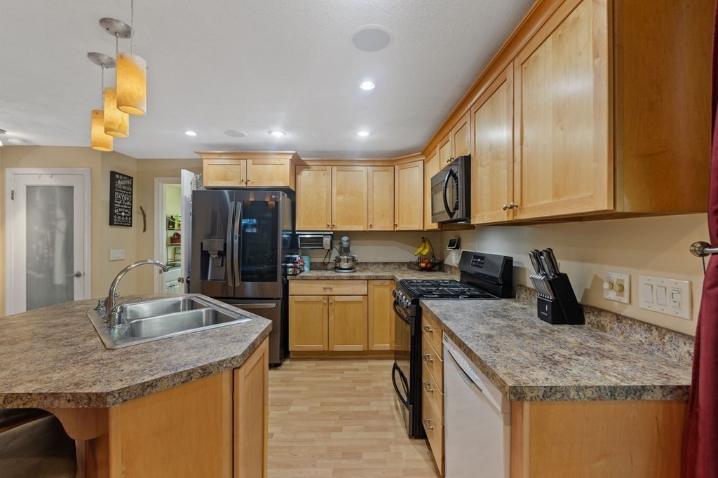 70 Colvintown Road Coventry, RI 02816 - Photo 3 of 41 a kitchen with a sink stove and refrigerator