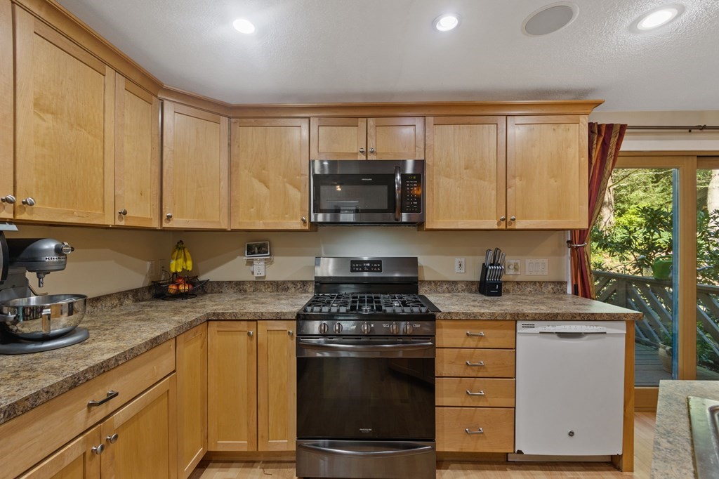 70 Colvintown Road Coventry, RI 02816 - Photo 6 of 41 a kitchen with granite countertop a stove sink and cabinets