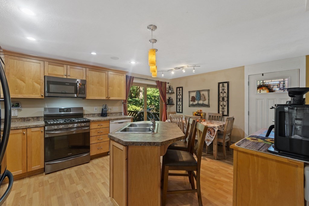 70 Colvintown Road Coventry, RI 02816 - Photo 7 of 41 a kitchen with sink a stove and chairs